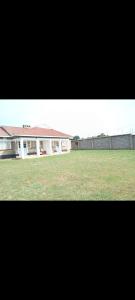 a building with a field of grass in front of it at JJHomes in Eldoret