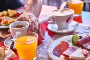 a person sitting at a table with a plate of food at MyContinental Sibiu in Sibiu