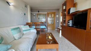 a living room with a couch and a coffee table at La Llongada 2-C in L'Escala
