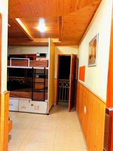 a room with two bunk beds and a hallway at Misfits Hostel and Cafe in Shoja