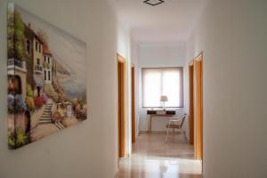 a hallway with a painting hanging on a wall at KAMVISSIS HOTEL in Tyros