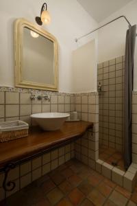 a bathroom with a sink and a mirror at Horizon Beach House by Andros Villas Collection in Andros +46 photos