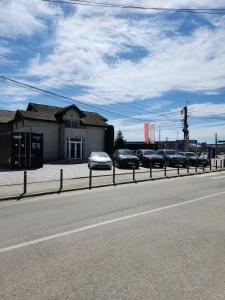 a row of cars parked on the side of a road at ILSA Properties in Craiova
