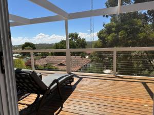 a porch with two chairs on a wooden deck at The Blue Nest, Clare in Clare