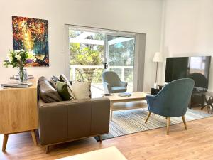 a living room with a couch and a tv at The Blue Nest, Clare in Clare