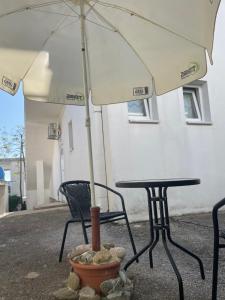 a table and two chairs with an umbrella at Mariyka Apartaments 2 in Sutomore
