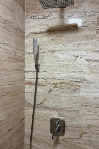 a shower with a hose attached to a wall at Tre Canne Vista in Budva +19 photos