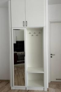 a white cabinet with a mirror in a kitchen at Tre Canne Vista in Budva