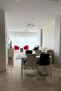 a living room with a dining table and chairs at Tre Canne Vista in Budva