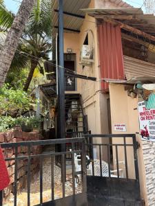 a house with a gate in front of it at Datta Swami Homestay in Malvan