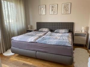 a bedroom with a large bed with two pillows at Ferienhaus Heimatgefühl in Würselen