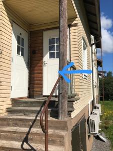 a house with a blue ribbon on the porch at Economy stay - Self Check-in in Vaasa +2 photos