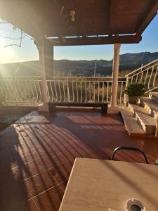 a patio with a table and benches on a balcony at Apartman Mirjana in Mlini