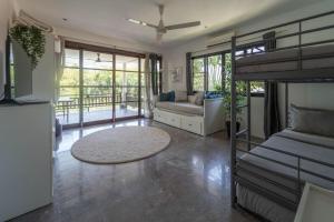 a living room with a bunk bed and a couch at Malee Beach C8 in Phra Ae beach +26 photos