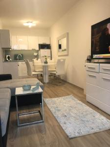 a living room with a couch and a table at Türkiz Apartman in Siófok