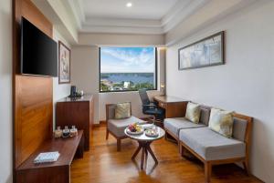 a living room with a couch and a table at Olivia International in Alleppey