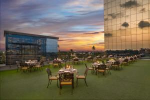 a group of tables and chairs on the roof of a building at Olivia International in Alleppey