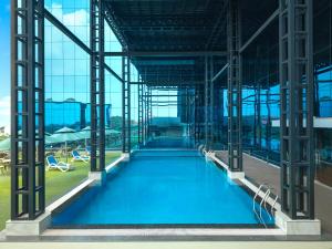 a large swimming pool inside of a building at Olivia International in Alleppey