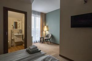 a hotel room with a bed and a bathroom at Leszczynowy Dworek in Gdańsk +10 photos