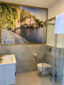 a bathroom with a painting on the wall at B&B Nest on the Lake in Lezzeno +64 photos