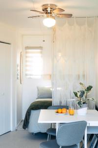 a bedroom with a table and a bed with oranges on it at Navigateur Ste-Luce in Sainte-Luce-sur-Mer +21 photos