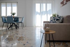 a living room with a couch and a table and chairs at Dimora Francesco in Domodossola
