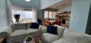 a living room with two white couches and a table at CUTTY SARK in Langstrand