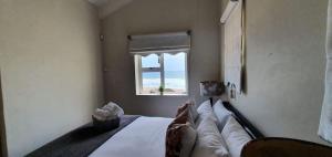 a bedroom with a bed with a view of the ocean at CUTTY SARK in Langstrand +13 photos