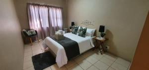 a bedroom with a large bed and a window at Dolphin View 20 @ LongBeach in Langstrand