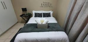 a bedroom with a bed with white sheets and pillows at Dolphin View 20 @ LongBeach in Langstrand +20 photos
