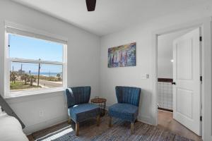 a bedroom with two blue chairs and a window at Steps to the Beach 3BR Coastal Home Sleeps 10 in Port Saint Joe