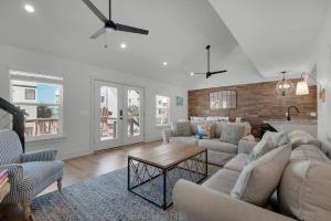a living room with a couch and a table at Steps to the Beach 3BR Coastal Home Sleeps 10 in Port Saint Joe +42 photos