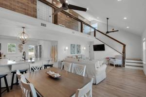 a kitchen and living room with a table and a dining room at Steps to the Beach 3BR Coastal Home Sleeps 10 in Port Saint Joe