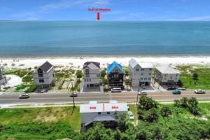 an aerial view of a beach with houses and the ocean at Beachfront 6BR Retreat w Gulf Views Sleeps 16 in Port Saint Joe
