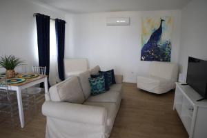 a living room with a couch and a table at Olívale - Turismo Rural in Campo Maior