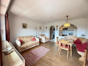 a living room with a couch and a table at Abendsonne in Krün
