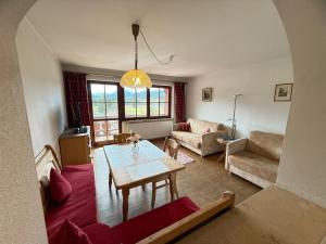 a living room with a table and a couch at Abendsonne in Krün