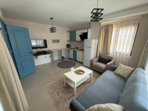 a living room with a blue couch and a table at Olea Alacati in Çeşme