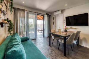a living room with a green couch and a table at Sea view SanNor by Vellaris, Luxury Mobile Home in Mali Lošinj