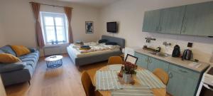 a kitchen and living room with a couch and a table at Vocell in Kutná Hora