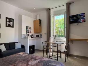 a bedroom with a bed and a table and a couch at SOBBORGO 34 - Affittacamere - in Sarzana