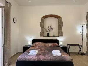 a bedroom with a bed with two towels on it at SOBBORGO 34 - Affittacamere - in Sarzana