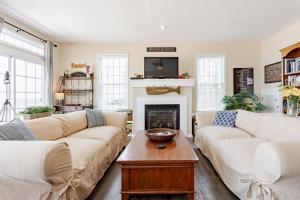 a living room with two couches and a fireplace at L'Hermione in Gloucester