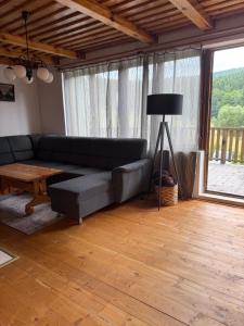 a living room with a couch and a table at Chata Monika in Frymburk