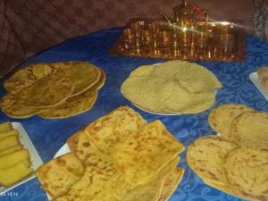 a blue table topped with chips and tortilla chips at Pergolas Tamakoucht in Ouarzazate +18 photos