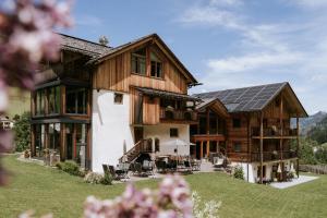 an exterior view of a house with a solar roof at Chalet Mornà in San Martino in Badia