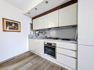 a kitchen with white cabinets and a stove at Al Funtanin in San Siro +9 photos