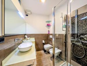 a bathroom with a sink and a toilet and a shower at Al Funtanin in San Siro