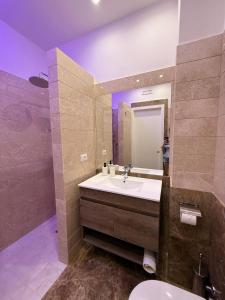 a bathroom with a sink and a mirror at Suite 55 in Trani
