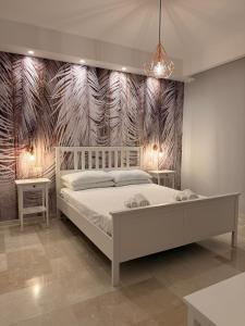 a bedroom with a bed and two tables and a wall at Suite 55 in Trani